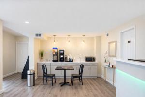 a kitchen with a table and chairs in a room at Quarters Inn & Suites in Antioch