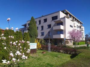a building with a garden in front of it at Gonda Apartments in Hradec Králové