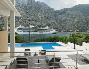 a cruise ship in the water next to a swimming pool at Studio apartment with heated pool in Kotor