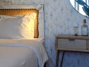 a bedroom with a bed and a nightstand with a bed sidx sidx at Infante Guesthouse in Lagos