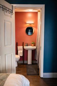 a bathroom with a sink and a mirror at Dog-friendly Seaview Apartment in Dungarvan