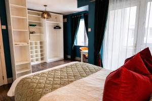 a bedroom with a large bed with blue walls at Dog-friendly Seaview Apartment in Dungarvan