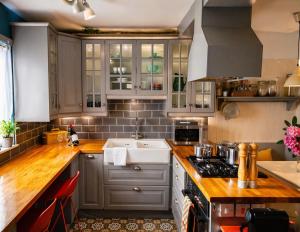 a kitchen with gray cabinets and a white sink at Dog-friendly Seaview Apartment in Dungarvan