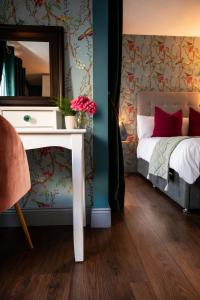 a bedroom with a bed and a table with a mirror at Dog-friendly Seaview Apartment in Dungarvan +14 photos