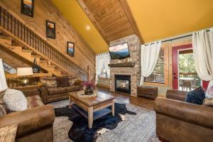 a living room filled with furniture and a fireplace at Hilltop Haven in Gatlinburg