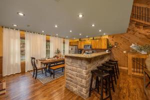 a kitchen and dining room with a stone bar at Hilltop Haven in Gatlinburg