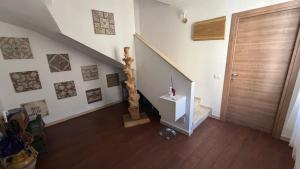 a hallway with a staircase and a wooden door at Grazia Vecchia 38 in Marsala