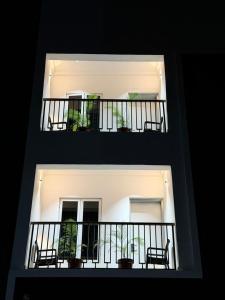 two balconies with chairs and plants on a building at Maydec Plus Homes & Apartments in Abuja