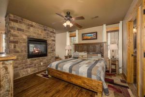 a bedroom with a bed and a stone wall at Hilltop Haven in Gatlinburg +65 photos