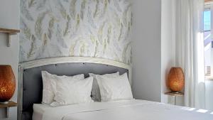 a bedroom with a bed with a floral wallpaper at Infante Guesthouse in Lagos +4 photos