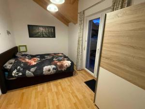 a bedroom with a bed and a sliding glass door at Villa Sonnenblick in Kötschach