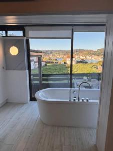 a bath tub in a room with a large window at Mar no Camiño. Terraza, bañera con vista al mar. in Brens +18 photos