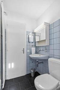 a bathroom with a white toilet and a sink at Studio with panoramic view in Bellerive