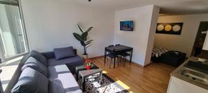 a living room with a blue couch and a table at La Maison V in Pontebba
