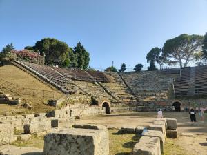 an amphitheater with people walking in front of it at Sweet Home in Oliveri