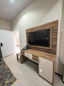 a living room with a large flat screen tv at شقــق فندقيـة in Hail