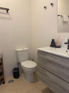 a bathroom with a toilet and a sink at Porta 28 in Quinta do Anjo +5 photos