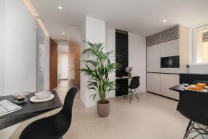 a kitchen and living room with a table and a plant at Borgo 39 Bed and Breakfast in San Marino
