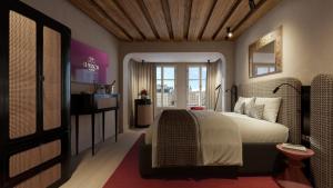 a bedroom with a large bed and a television at La Maison in Salzburg