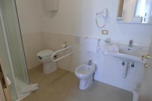 a bathroom with a toilet and a sink at Hotel Cantore in Genova