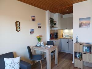 a kitchen and dining room with a table and chairs at Sielpferdchen Bensersiel in Bensersiel