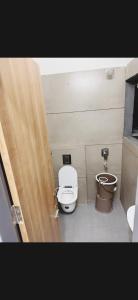 a bathroom with a toilet and a bidet at Hotel Aura Avenue in Bathinda