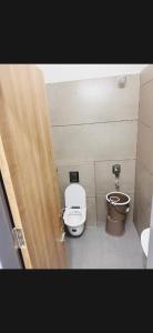 a bathroom with a toilet and a bidet at Hotel Aura Avenue in Bathinda