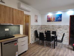 a kitchen and dining room with a table and chairs at Lugas Apartman in Tapolca