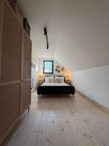 a bedroom with a bed and a window at Wooden House Kaszuby in Borsk