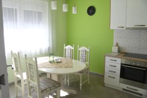 a kitchen with a table and chairs in a kitchen at Prestige in Šabac