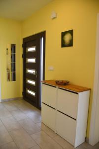 a kitchen with yellow walls and a counter with a door at Prestige in Šabac