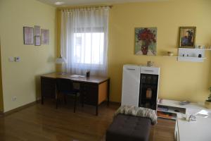 a room with a desk and a table and a chair at Prestige in Šabac