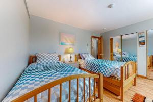a bedroom with two beds and a mirror at Lakeside Delight, unit 423 in Laconia +21 photos