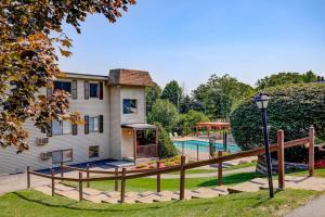 a house with a swimming pool and a fence at Lakeside Delight, unit 423 in Laconia