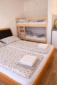 two bunk beds in a room with towels on them at Halalko Konak in Šmarje-Sap