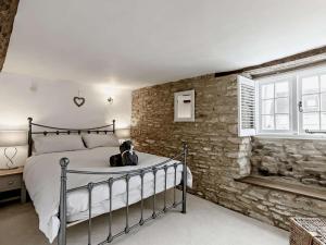 a bedroom with a bed and a stone wall at 3 Bed in Witney oc-82478 in Hailey