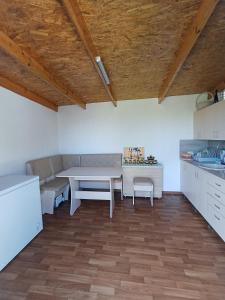 a kitchen with a table and a table and a counter at Arca lui Roman in Furceni