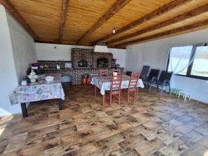 a living room with a table and chairs and a fireplace at Cabanele Avoca in Avrig