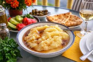 a bowl of food on a table with a plate of food at Chateau Chao in Khulo +22 photos