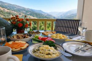 a table with plates of food on it with a view at Chateau Chao in Khulo