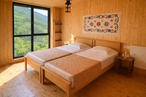 a bedroom with a large bed with a large window at Chateau Chao in Khulo
