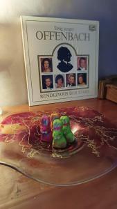 a book and two toy figurines on a table next to at Vila Rapsodia Sinaia in Sinaia