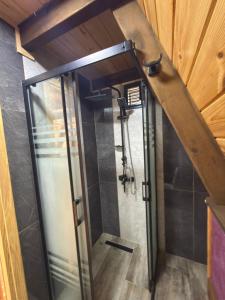 a shower with a glass door in a bathroom at Danzi camping tiny house in Kise +68 photos