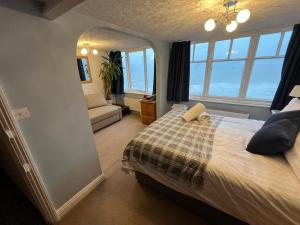 a bedroom with a bed and a large window at Haddock Hideaway at The Whiteley in Scarborough