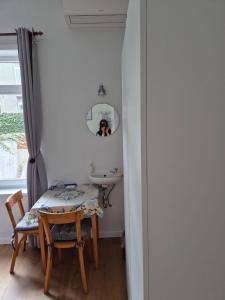a room with a table and a sink and a mirror at Guest house Adonis in Bruges
