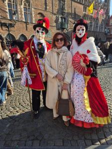 three people dressed in costumes standing on a street at Guest house Adonis in Bruges