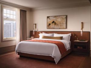 a bedroom with a large bed and a window at The Huntington Hotel in San Francisco