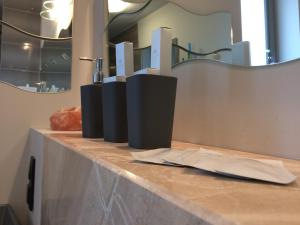 a counter top with a sink and a mirror at Apartament Nad Galerią in Stargard +29 photos