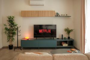 a living room with a tv with the netflix sign on it at Tan-Nanna by Shmoo, Sliema Ferries in Sliema