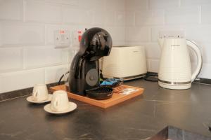 a kitchen counter with a black mixer on a cutting board at Tan-Nanna by Shmoo, Sliema Ferries in Sliema